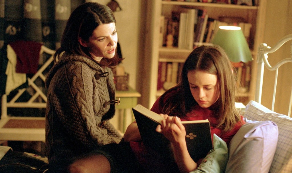 Lorelai (played by Lauren Graham) talking to Rory (played by Alexis Bledel) as she reads a book