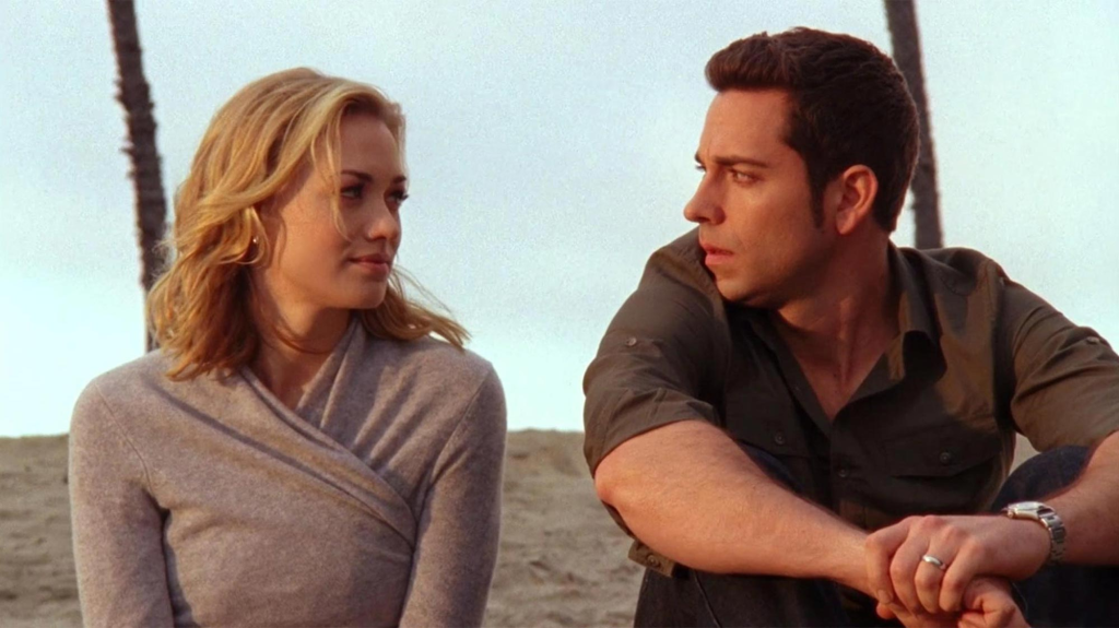 Still of Sarah (played by Yvonne Strahovski) sitting next to Chuck (played by Zachary Levi) on a beach from the series finale of 'Chuck'